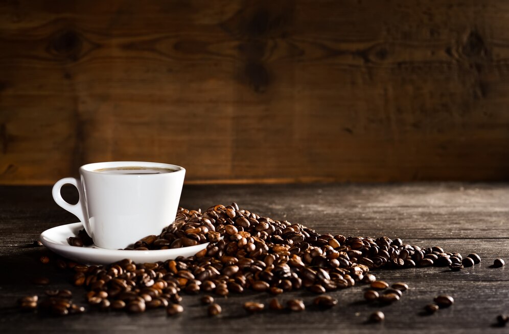 cup-coffee-with-pile-coffee-beans_1112-438